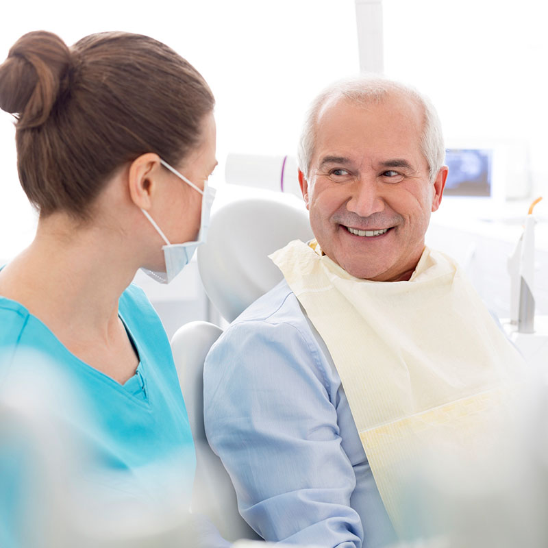 Happy man talking to his dentist