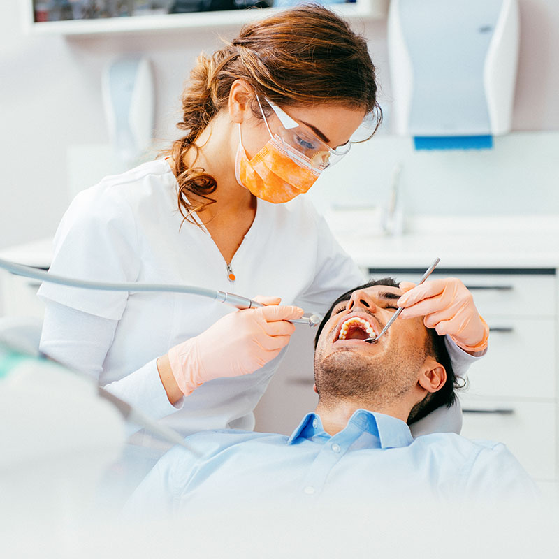 Dentist checking patient's teeth