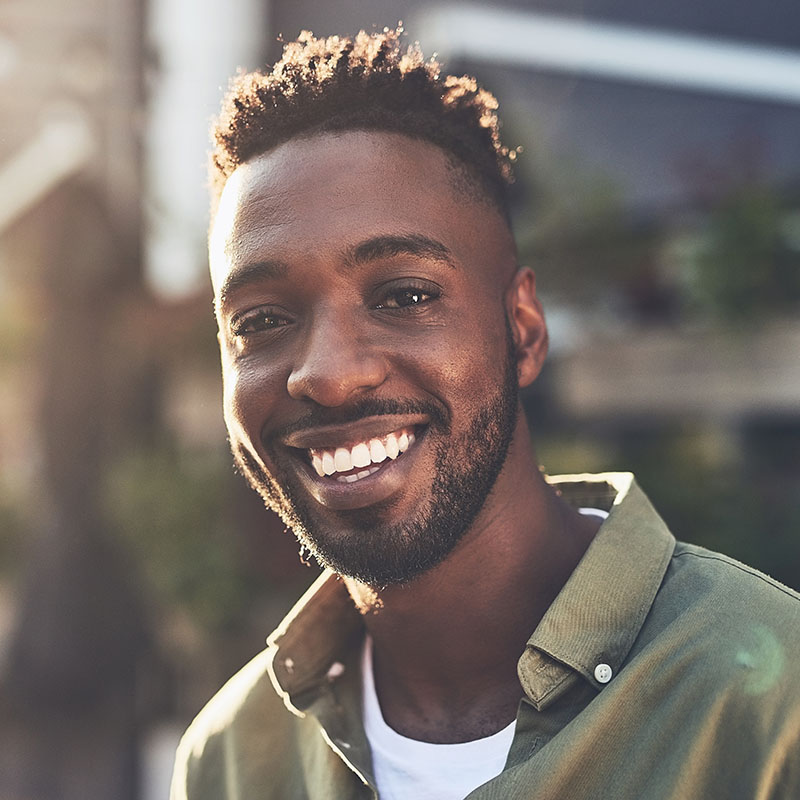 Young man smiling and showing his teeth