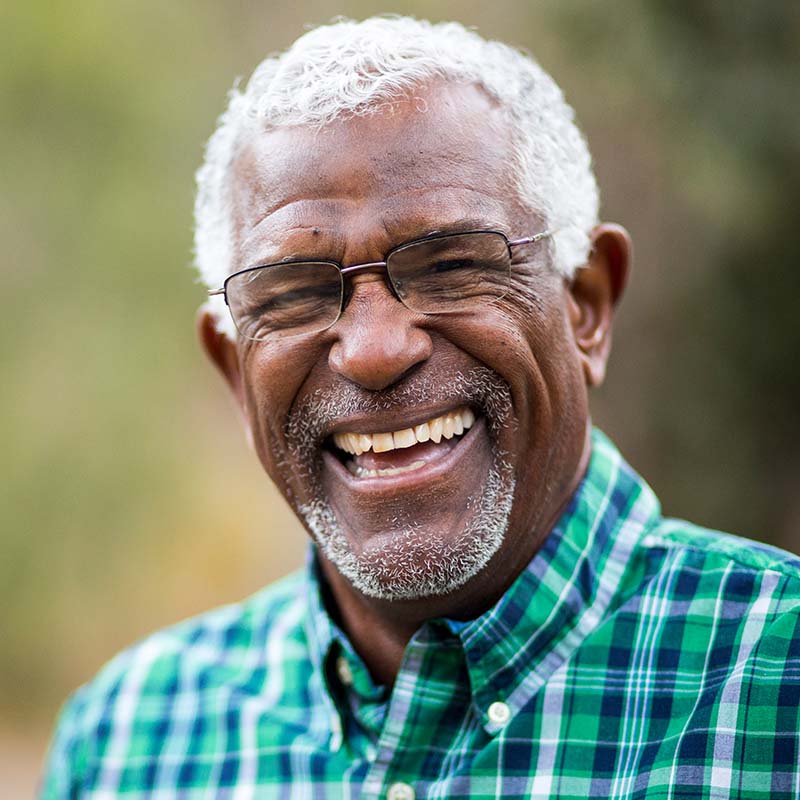 Happy senior man smiling showing his teeth